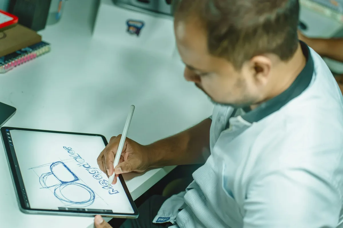 Designer sketching a logo for a design prompt tags example